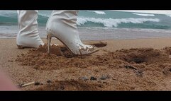 Pretty girl in long heels walks on a snowy beach