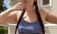 Smoking on the balcony, jean shorts and a sports bra, hair in braids - Smokingrapunzel