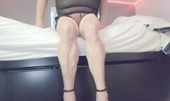 Tempest sits on bed with stripper heels