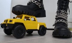 Crushed a toy car with black boots d