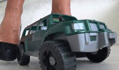 Crushed a toy car with black shoe with high heels c