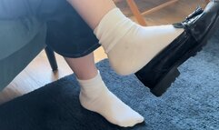 Dangling in white ankle socks and patent black flat loafers