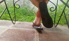 The soles of the feet while wearing flip-flops and seen from the back up close (3)