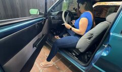 Karlotta smokes a cigarette in the Fiat Uno