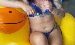 girl in swimsuit poping fliwer ballons