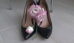 She crushed beautiful flowers with black leather shoes a