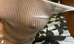 Brunette in a fishnet playing with her slit