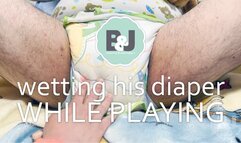 Wetting his diaper while playing