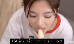 Teach beautiful girl to eat banana