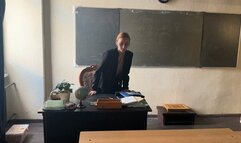 The teacher is waiting for his students at school on the first of September and while waiting he is playing with shoes, admiring them
