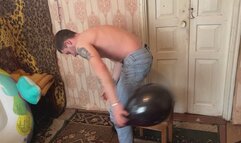 Jason pops balloons in torn blue jeans