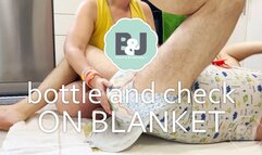 Bottle and check on blanket