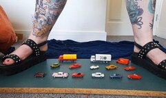 Giantess Jayne crushes 14 wiking tiny toy cars and trucks in chunky black flat sandals closeup ground view