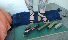Giantess Jayne crushes some train coaches and small cars in chunky heels toy car crush left view