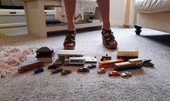 Back by popular demand GIANTESS Charn crushes small cars, buildings, buses in black wedge sandals closeup view