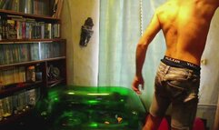 Jason sit pop 40 balloons on green couch