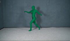 Green man in zentai in transparent vacuum bed with flips and vibration