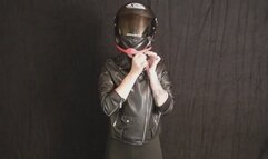 Sophia tries on the right size motorcycle helmet