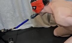 BDSM session; slave sucks dildo on sex machine while I am spanking and trampling him