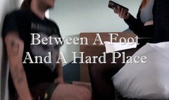 Between A Foot And A Hard Place