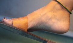 Foot fetish and slippers dangling close-up