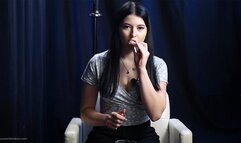 Brunette with mysterious look smoking all white cigarette