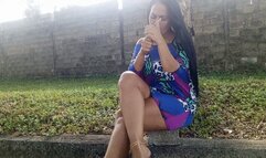 Beautiful woman in the park crossing her legs while smoking cigarettes (3)