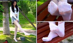 Dirty Feet - Girl in white stockings tramples the grass in the park with her bare feet