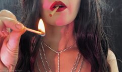 A lady with red lips exquisitely smokes a cigarette