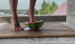 Beautiful feet ruthlessly crushed a watermelon