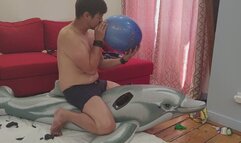 Cedric pop his inflatable dolphin