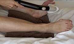 Karina vacs her feet on bed with the brush