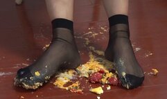 Food Crush - Girl in black stockings crushes cream puffs and tomatoes to prepare your food