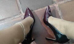 Stiletto heels dangle from feet with pantyhose stockings (2)