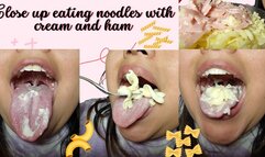 Close up eating noodles with cream and ham