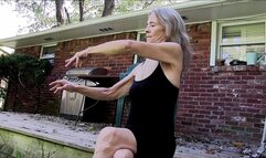 Lilly sitting on the deck, running her fingers through her long granny hair