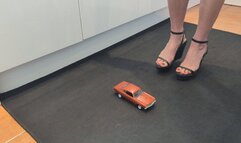 Giantess Raven Lee crushes a 1970s American car in sexy black wedges with painted toenails close high right view