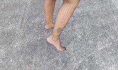Beautiful lady with pronounced arches walks barefoot and wearing fishnet stockings (3)