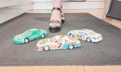 Giantess Raven Lee crushes a 3 old American NAS cars in big black wedges with painted toenails close up ground view