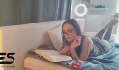 Relaxing barefoot smoking while reading a book