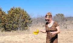 Naughty Nora Blowing A Big Yellow Balloon in the Hot Sun