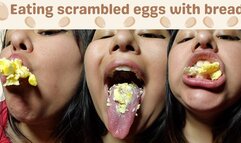 Eating scrambled eggs with bread