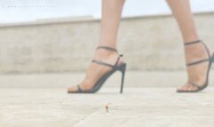 Giantess in black strappy heels and tiny speck