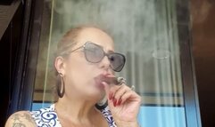 Stepmother smoking a cigar on the balcony (Amateur video)