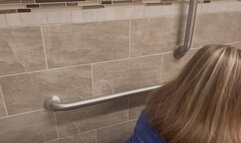 One big log in a public toilet from behind