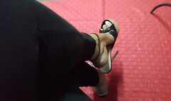 The beautiful Angelin's mules hang from her feet as she stands with her legs crossed (1)