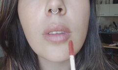 Kissing and appliying lipglosses close-up