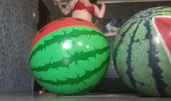 girl riding on 2watermelon beachballs