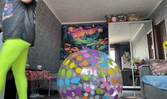 Girl in leggings riding on intex dotted beachball