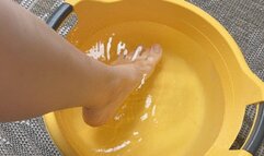 A young woman makes foot baths